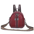 Versatile burgundy shell-shaped backpack for women with textured cowhide and striped strap - Red