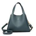 Elegant fog blue pebble leather bucket bag for women with gold kangaroo logo - Blue