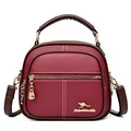 Deep red pebbled leather small round crossbody bag for women with triple zipper design - Burgundy