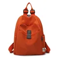 Vibrant orange nylon anti-theft backpack with front leather buckle and brand tag - Orange