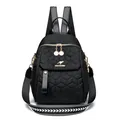 Black quilted backpack for women featuring honeycomb stitching and golden kangaroo logo - Black
