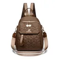 Quilted geometric pattern backpack in dark brown with gold kangaroo logo and zipper - Brown