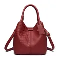 Deep red leather bucket bag featuring crocodile and lychee textures with a bear charm - Crocodile Pattern Red