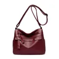 Deep burgundy leather crossbody bag featuring quilted rhombus pattern and adjustable strap - Red