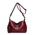 Elegant burgundy crescent leather handbag with lychee texture and tassel charm - Burgundy