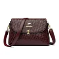 Women's woven leather crossbody bag in deep wine red featuring golden kangaroo hardware - Red