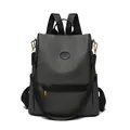 Deep charcoal grey water-resistant backpack with kangaroo logo and gold hardware - Black