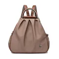 Brown fabric convertible backpack with metal handle and silver floral accent charm - Red Brown