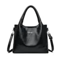 Elegant black faux leather tote bag with silver metal logo and adjustable strap - Black