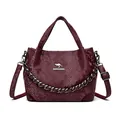 Chic burgundy snakeskin pattern handbag with kangaroo logo and metallic chain strap - Red