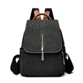 Chic black denim backpack with silver chain tassels and brown leather accents - Black
