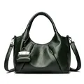 Dark green croissant bag in lychee leather with a small charm and long strap - Green