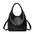 Black leather bucket bag with crocodile and lychee textures and a bear charm - Crocodile Pattern Black