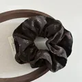 Macro detail of brown floral scrunchie showing delicate chiffon texture and vintage pattern - Scrunchie / Coffee Floral