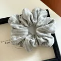 Detail of grey and white striped knit fabric scrunchie with soft ribbed texture - Light Grey Stripe