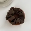 Detail of a chocolate brown silk satin scrunchie displayed on a wooden tray - M / Dark Coffee
