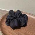 Elegant satin scrunchie in deep black finish displayed on a walnut wooden tray - Navy Blue