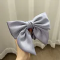 Detail of a large light blue satin bow hair tie with premium silk luster for women - Sky Blue