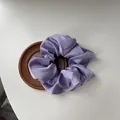 Elegant light purple large silk satin scrunchie displayed on a minimalist wooden coaster - Purple