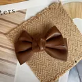 Vintage brown faux leather bow hair clip with textured finish and layered design - Coffee