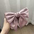 Elegant mauve satin bow hair scrunchie with a silky finish and voluminous design - Pink