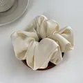 Elegant cream silk satin scrunchie with soft pleats on a minimalist wooden tray - L / Off-white