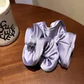 Oversized lavender satin scrunchie with layered ruffle edges on a wooden background - Plum Purple