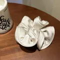 Elegant cream white oversized satin scrunchie with silk luster and ruffled edges - Creamy Apricot