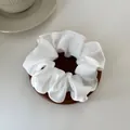 Silky cream white satin scrunchie with soft folds on a minimal wooden tray - M / White