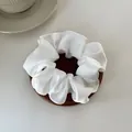 Elegant ivory white satin hair scrunchie with silky texture on wooden coaster - M / White