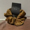 Detail of brown velvet hair scrunchie with silver bead accents on a display card - Brown Coffee
