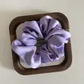 Elegant lavender purple satin scrunchie with silky texture in a wooden frame - M / Light Purple