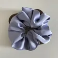 Elegant lavender silk satin scrunchie with French label on wooden display base - L / Light Blue