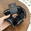 Eleganter Haargummi aus schwarzem Samt mit Fransen und edlem koreanischem Design - Schwarz