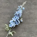 Artificial light blue delphinium stem with delicate petals on a grey texture - Light Blue