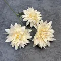 Three-headed cream white artificial dahlia flowers with green stems on grey background - Champagne