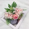 Artificial pink rose and hydrangea bouquet with green leaves on plush background - Rose Red