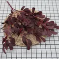 Artificial burgundy peanut leaves spray with berries on woven mat for home decor - Wine Red