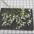 Artificial white gypsophila baby's breath flowers on a book for home decoration - White