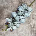 Single light blue artificial orchid stem with detailed blue veins on gray cement background - No. 4 Light Blue