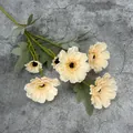 Artificial zinnia branch with six cream yellow flower heads and realistic green leaves - Champagne