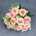 Pink and white gradient artificial rose bouquet with green leaves on dark fabric - Pink