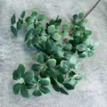 Close-up of realistic faux greenery branch showing detailed veins and green oval leaves - Medium / Dark Green