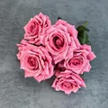 Vintage dusty pink artificial rose bouquet with five textured flower heads on dark fabric - Rose Red