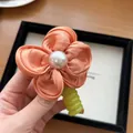 Orange silk flower hair tie with large white pearl and lime green spiral band - Orange