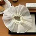 Detailed view of a white oversized organza scrunchie with elegant ruffled layers - Beige