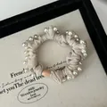 Coletero elegante de satén crema con perlas y tachuelas de estilo vintage francés - Beige