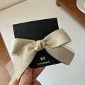 Champagne gold double-layer mesh bow hair clip with satin ribbon on black card - Beige