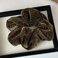 Close-up of olive green velvet scrunchie showing rich ribbed texture and soft fabric - Olive Green