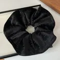 Scrunchie in velluto nero stile francese con strisce glitterate e texture elegante - Nero Temperamento